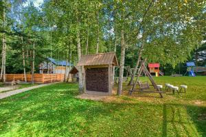a park with a playground with a play structure at APARTAMENTY SPA & RESORT BUKOWIEC in Polańczyk