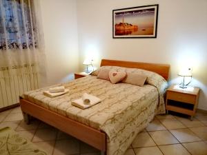 1 dormitorio con 1 cama con 2 toallas en Room and Apartment Lea, en Rovinj