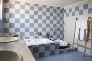 a bathroom with a bath tub and a sink at Akti in Nafpaktos +37 photos