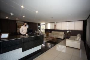 a man wearing a face mask in a hotel lobby at Havana Express in Uberaba