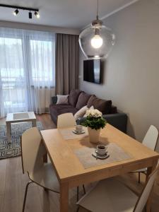 a living room with a table and a couch at Apartament Baltic in Świnoujście