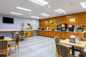 a fast food restaurant with wooden walls and tables and chairs at Quality Inn Newport in Newport