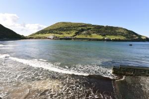 an island in the middle of a body of water at Porto Pim Bay in Horta