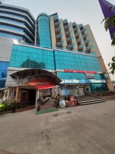 a large building with a sign on the side of it at Hotel Valley Garden in Sylhet