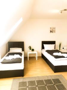 - une chambre avec 2 lits et une table dans l'établissement SUNNYHOME Monteurwohnungen und Apartments nahe Regensburg, à Nittendorf