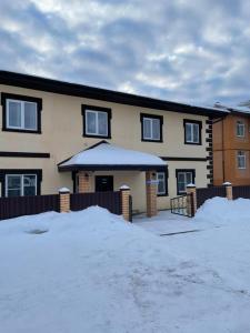 a house with snow in front of it at Sheremetievo-Transit Hotel in Khimki