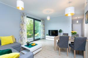 a living room with a couch and a table at Natural Hel Apartamenty in Hel
