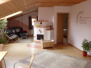 a living room with a fireplace and a couch at Fembacherhof in Siegsdorf