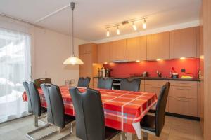 a kitchen with a table and chairs in a room at Ferienwohnung Margeli in Adelboden