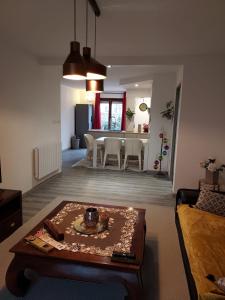 a living room with a table and a dining room at Residence du Vieux Chateau jardin & parking gratuit in Mulhouse