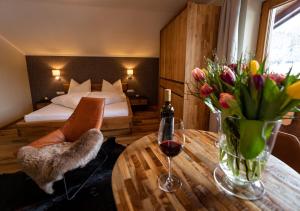 a hotel room with a table with a bed and a bedroom at Gasthaus-Pension Golfvilla in Pertisau