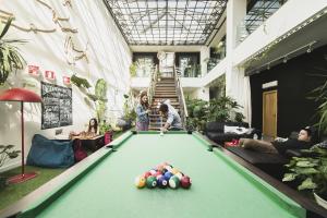a group of people playing pool in a building at Lisbon Destination in Lisbon