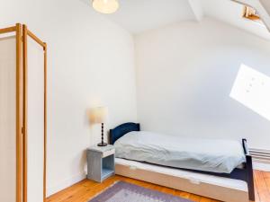 a bedroom with a bed and a mirror at Villa Le Cyclamen by Interhome in Courseulles-sur-Mer +8 photos