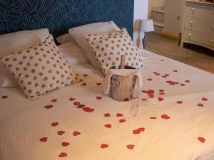 a bed with a bunch of hearts on it at Auberge Gardoise in Vallérargues +27 photos