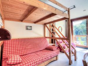 a living room with a couch and a bunk bed at Studio Soyouz Vanguard-10 by Interhome in Le Corbier
