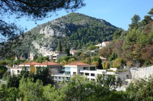 a town in front of a mountain at La Perle d'Eze - Aparthotel in Èze