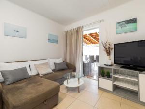 a living room with a couch and a flat screen tv at Holiday Home Nataly by Interhome in Vela Luka +23 photos