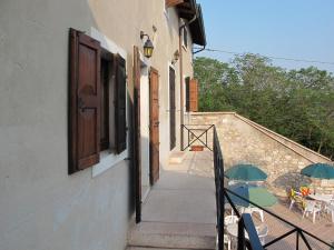 a stairway with a patio with tables and umbrellas at Apartment Ca' Pignoi-5 by Interhome in Garda