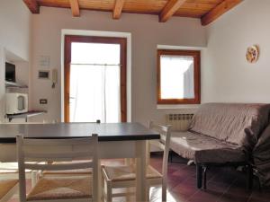 a living room with a table and a couch at Apartment Ca' Pignoi-5 by Interhome in Garda