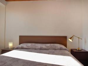 a bedroom with a large bed and two night stands at Apartment Ca' Pignoi-5 by Interhome in Garda +15 photos