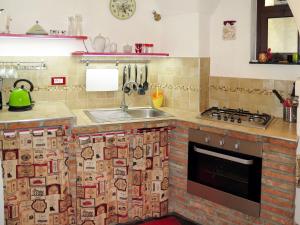 een keuken met een spoelbak en een fornuis bij Apartment Mulino Rossi - PTB170 by Interhome in Pietrabruna