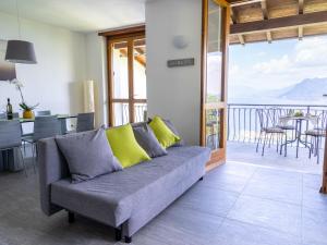a living room with a couch and a balcony at Holiday Home Ca' delle Isole by Interhome in Stresa +32 photos