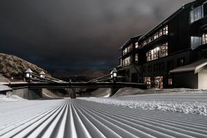 a snow covered street in front of a building at Skigaarden in Hemsedal