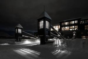 a building with two lights in the snow at night at Skigaarden in Hemsedal