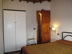 a bedroom with a bed and a wooden door at Apartment Ca' Pignoi-6 by Interhome in Garda