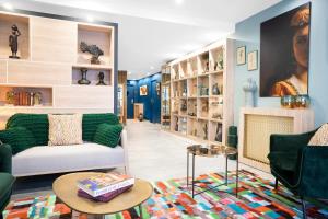 a living room with two couches and a fireplace at Residhome Saint Ouen in Saint-Ouen