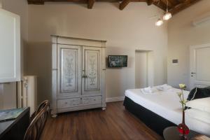 a bedroom with a bed and a cabinet and a table at Parione Uno in Florence