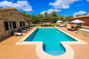una piscina con patio y una casa en Cas Misser en Algaida