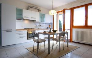 a kitchen with a table and chairs in a room at UR-NEST Fantin in Bologna
