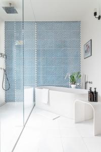 a bathroom with a tub and a glass shower at BMORE Apartments in Milan