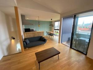 a living room with a couch and a table at Stella House Gemini ステラハウス ジェミニ in Fujikawaguchiko