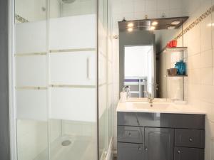a bathroom with a shower and a sink and a mirror at Studio Le Grand Galion-3 by Interhome in Le Grau-du-Roi