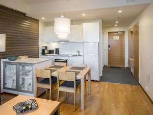 a kitchen with a table and chairs in a room at Holiday Home Nordic chalet 9102 by Interhome in Ylläsjärvi