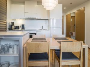 a kitchen with a large wooden table and chairs at Holiday Home Nordic chalet 9102 by Interhome in Ylläsjärvi +12 photos