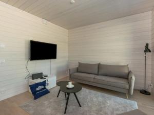 a living room with a couch and a tv at Holiday Home Kasnäs marina b11 by Interhome in Kasnäs
