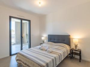 a bedroom with a large bed with two towels at Apartment St Joseph-1 by Interhome in Porto-Vecchio +17 photos