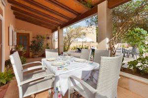 a white table and chairs on a patio at Villa Angela in Urbanicacion ses palmeres