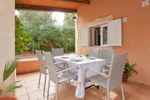 a white table and chairs on a patio at Villa Angela in Urbanicacion ses palmeres