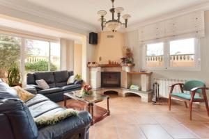 a living room with a couch and a fireplace at Villa Angela in Urbanicacion ses palmeres +16 photos