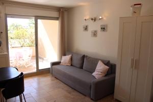 a living room with a couch and a window at Holidays Hyeres in Hyères