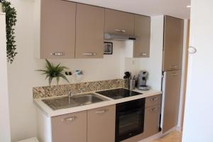 a kitchen with a sink and a counter top at Holidays Hyeres in Hyères