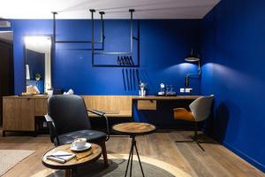 a blue room with a desk and a chair at Guest House de la Valette in Valletta