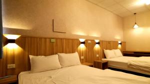 Voodi või voodid majutusasutuse Duo Yuan Hua B&B toas