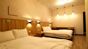 Voodi või voodid majutusasutuse Duo Yuan Hua B&B toas