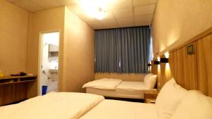 Voodi või voodid majutusasutuse Duo Yuan Hua B&B toas