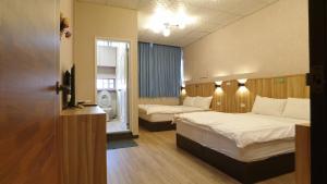 Voodi või voodid majutusasutuse Duo Yuan Hua B&B toas